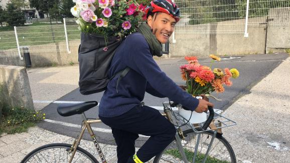 At the end of his day on the roof, Tran-Phi Vu gets on his bike to ensure the deliveries of bouquets.