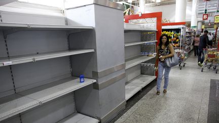 La cliente d'un supermarch&eacute; de Caracas dans les rayons vides, le 13 mai 2013, alors qu'une p&eacute;nurie de produits de premi&egrave;re n&eacute;cessit&eacute; frappe le Venezuela.&nbsp; (JORGE SILVA / REUTERS)