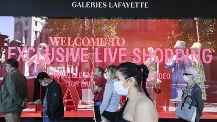 Des personnes masquées devant les Galeries Lafayette, à Paris, le 30 mai 2020.&nbsp; (ALAIN JOCARD / AFP)