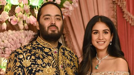 Radhika Merchant (R) and her fiance Anant Ambani during a ceremony before their wedding on July 5, 2024 in Mumbai, India. (SUJIT JAISWAL / AFP)