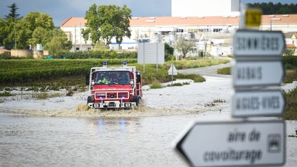 Un camion de pompiers sur une route inondée par les intempéries à Aigues-Vives, dans le Gard, mardi 14 septembre. (SYLVAIN THOMAS / AFP)