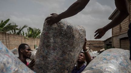 Dans la capitale ghanéenne Accra, au lieu de se plaindre comme la plupart des habitants, de la multiplication des monticules de déchets le long des rues, l'ingénieur Nelson Boateng a eu l'idée de les transformer en argent. Le plastique est recyclé en pavés destinés à la construction des routes, car le jeune entrepreneur a fait ce constat: sur les 22.000 tonnes de déchets en plastique produites par le Ghana chaque année, 2% seulement sont récupérées.
 (Cristina ALDEHUELA / AFP)