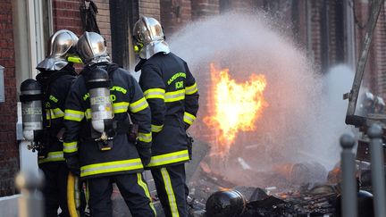 Des pompiers tentent d'&eacute;teindre l'incendie d'un camion transportant du gaz, &agrave; Lomme (Nord), le 28 d&eacute;cembre 2013. (PHILIPPE HUGUEN / AFP)