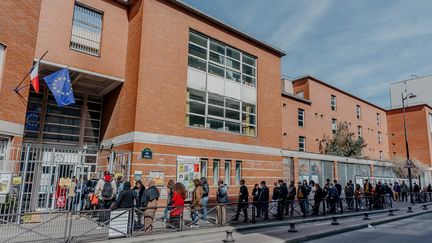 Des électeurs et électrices attendent pour voter au premier tour de l'élection présidentielle, le 10 avril 2022 dans le 19e arrondissement de Paris.&nbsp; (PIERRE MOREL / FRANCEINFO)