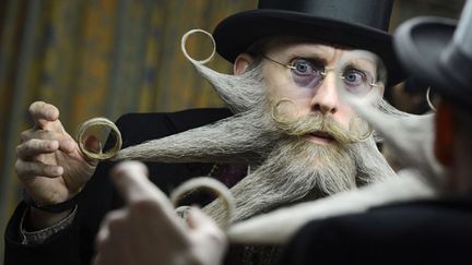 L'Am&eacute;ricain Aame Bielefeldt coiffe sa barbe avant de participer au championnat allemand de barbe &agrave; Bad Schussenried (Allemagne), le 21 avril 2012. (FELIX KAESTLE / AP / SIPA)