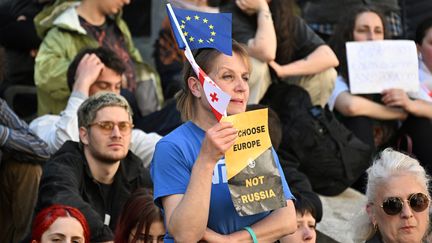 Des manifestants protestent contre un projet de loi sur l'influence étrangère, qu'ils comparent à une loi russe, à Tbilissi, en Géorgie, le 16 avril 2024. (VANO SHLAMOV / AFP)