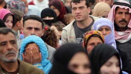 Les réfugiés syriens attendent leur tour à un centre d'inscription de l'Agence des Nations Unies pour les réfugiés à Tripoli (au nord du Liban), le 3 avril 2014. (AFP PHOTO / JOSEPH EID)