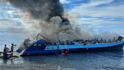 Le ferry&nbsp;"Mercraft 2"&nbsp;en feu près de la ville de Real, dans la province de Quezon, aux Philippines, le 23 mai 2022. (PHILIPPINE COASTGUARD / AFP)