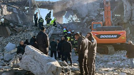 Firefighters and members of the security forces in the rubble of a building in Erbil, the capital of Iraqi Kurdistan, hit by missiles, January 16, 2024. (KURDISTAN 24 / AFP)