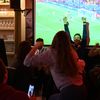 Des supporters de la France fêtent un but des Bleus contre l'Australie dans un bar à Paris, le 22 novembre 2022. (ALAIN JOCARD / AFP)