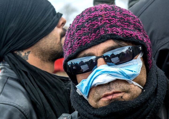 Un migrant iranien pose avec la bouche cousue, le 2 mars 2016, dans la "jungle" de Calais (Pas-de-Calais). (PHILIPPE HUGUEN / AFP)