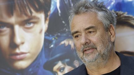 Luc Besson devant l'affiche de "Valérian" à Rome (13 septembre 2017). Le film n'a pas suffi à renflouer les caisses de sa société de production, qui a annoncé 22 suppressions de postes.
 (Donatella Giagnori / EIDON / MAXPPP)