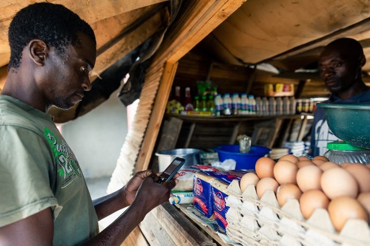 Payer ses menus achats par téléphone devient une pratique de plus en plus fréquente en Afrique comme ici à Harare, la capitale du Zimbabwe, en décembre 2019. (JEKESAI NJIKIZANA / AFP)