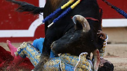 Le matador espagnol, Ivan Fandino manque d'&ecirc;tre transperc&eacute; par un taureau lors d'une corrida &agrave; Pampelune (Espagne), le 11 juillet 2013. (SUSANA VERA / REUTERS)