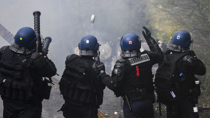 Des gendarmes mobiles lancent des grenades lacrymogènes, le 15 avril 2018 sur la ZAD de Notre-Dame-des-Landes (Loire-Atlantique). (DAMIEN MEYER / AFP)