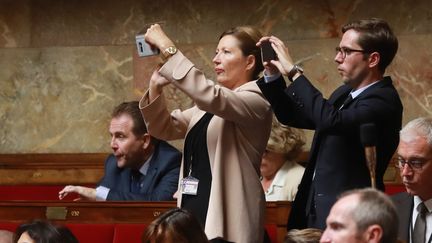 Les néo-députés La République En Marche&nbsp;Natalia Pouzyreff et Pieyre-Alexandre Anglade prennent des photos lors des questions au gouvernement à l'Assemblée nationale, le 26 juillet 2017.&nbsp; (JACQUES DEMARTHON / AFP)