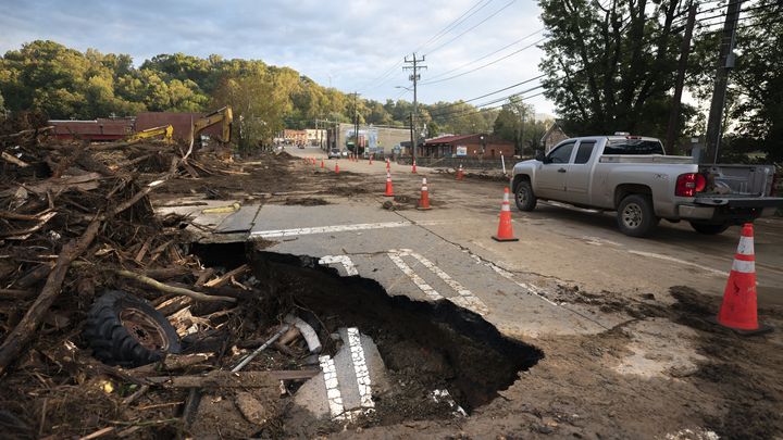 A motorist drives past flood damage on a bridge crossing the Mill Creek River in the aftermath of the hurricane September 30, 2024 in Old Fort, North Carolina. (SEAN RAYFORD/GETTY IMAGES NORTH AMERICA)