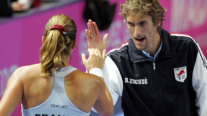 Nicolas Escud&eacute;, capitaine de l'&eacute;quipe de France de Fed Cup, encourage Am&eacute;lie Mauresmo (de dos), en f&eacute;vrier 2009, &agrave; Orl&eacute;ans, lors du tour contre l'Italie. (REMY DE LA MAUVINIERE/AP/SIPA / AP)