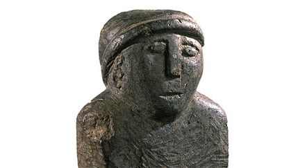 Statuette en pierre verte trouvée en 1988 à Paule (Côte-d&#039;Armor). Le personnage représenté porte les attributs du barde, la lyre et le torque (collier métallique rigide).
 (Yves Menez - Hervé Paitier - INRAP)