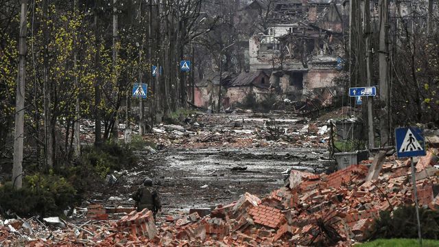 Two Russian soldiers make their way through the debris, in a street in Bakhmout destroyed by fighting, April 14, 2023. (EVGENY BIYATOV / SPUTNIK / SIPA)