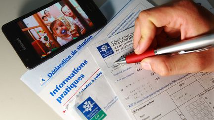 Un homme remplit une d&eacute;claration de ressources pour la Caisse d'Allocations Familiales, &agrave; Bordeaux (Gironde), le 8 octobre 2014. (  MAXPPP)