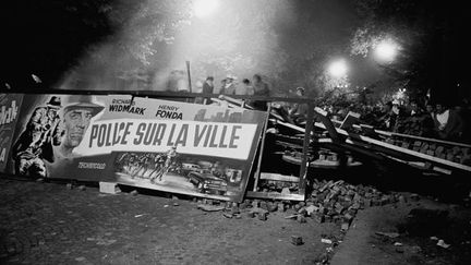 Des étudiants tiennent une barricade, boulevard Saint-Michel à Paris, dans la nuit du 10 au 11 mai 1968. (SIPA)