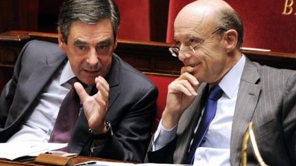 Le Premier ministre, François Fillon, et le ministre des Affaires étrangères, Alain Juppé, à l'Assemblée nationale en décembre à Paris (AFP PHOTO BERTRAND GUAY)