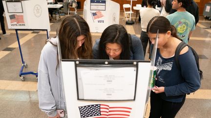 Une New-Yorkaise vote dans un bureau de Manhattan, en compagnie de ses deux filles, mardi 5 novembre. (NEW YORK DAILY NEWS / TRIBUNE NEWS SERVICE / GETTY IMAGES)