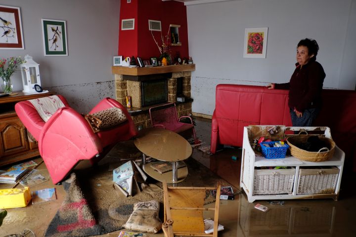 Une habitante de Villegailhenc (Aude)&nbsp;au milieu de son salon dévasté, le 15 octobre 2018, après des inondations. (ERIC CABANIS / AFP)