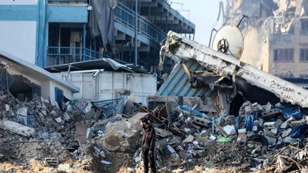 A man in front of the ruins of a school operated by UNRWA, in Gaza, February 10, 2024. (AFP)