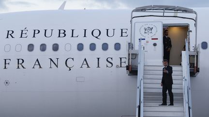 Emmanuel Macron monte à bord d'un avion pour se rendre en Nouvelle-Calédonie, depuis l'aéroport d'Orly (Val-de-Marne), le 21 mai 2024. (LUDOVIC MARIN / AFP)