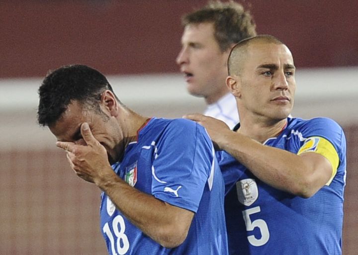 Fabio Cannavaro and Fabio Quagliarella are inconsolable: Italy left the 2010 World Cup in the first round.  (FILIPPO MONTEFORTE / FILES)