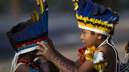 De jeunes indiens de la tribu Paresi enfilent leurs habits traditionnels en marge de la conf&eacute;rence Rio+20, la&nbsp;Conf&eacute;rence des Nations unies sur le d&eacute;veloppement durable qui se tient &agrave; Rio de Janeiro (Br&eacute;sil), le 13 juin 2012. (FELIPE DANA / AP / SIPA)