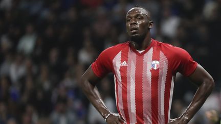 Usain Bolt lors du match de gala entre l'équipe de foot de la Fifa et l'équipe de France 98, le 12 juin 2018, à Nanterre (Hauts-de-Seine). (THOMAS SAMSON / AFP)