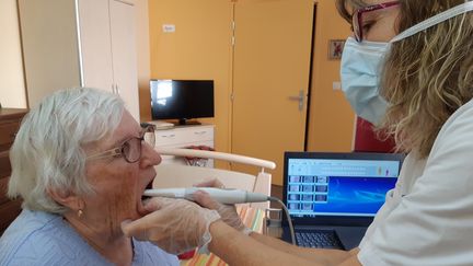 &nbsp;L’infirmière Yvette Bordas filme la dentition d'Anne-Marie, résidente à l’Ehpad de Sancerre. Le film et les photos sont ensuite analysés par un dentiste, à l’hôpital de Bourges. (SOLENNE LE HEN / RADIO FRANCE)