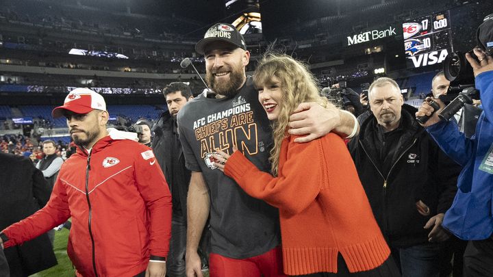 Le joueur des Kansas City Travis Kelce bras dessus bras dessous avec sa petite amie, la star de la pop Taylor Swift, après la victoire des Chiefs contre les Baltimore Ravens, le 28 janvier 2024 (JULIO CORTEZ / AP)