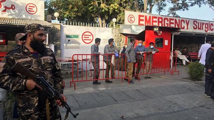 Un taliban, armé, surveille l'entrée d'un hôpital qui prend en charge les blessés après une explosion à Kaboul (Afghanistan), le 3 octobre 2021. (HOSHANG HASHIMI / AFP)