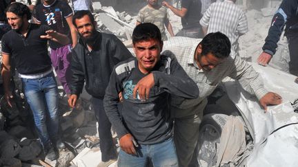 Des habitants de Maaret al-Noumane (nord de la Syrie) apr&egrave;s des bombardements de l'arm&eacute;e syrienne, le 18 octobre 2012. (BULENT KILIC / AFP)