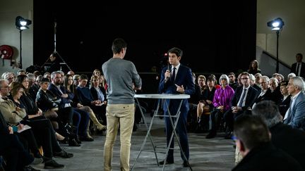 Prime Minister Gabriel Attal speaks with a market gardener during a public meeting in Saint-Laurent-d'Agny (Rhône), January 20, 2024. (JEFF PACHOUD / AFP)