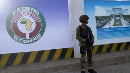 Un soldat devant un site de la Communauté économique des Etats de l'Afrique de l'ouest (Cédéao) à Abuja (Nigéria), le 4 décembre 2022. (KOLA SULAIMON / AFP)