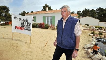 Jacques Voyer devant sa maison de La Faute-sur-Mer, classifiée en zone noire, en avril 2010. (AFP/FRANK PERRY)