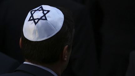 A man with a kippah near a synagogue.  (RONNY HARTMANN / AFP)