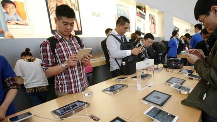 Des clients au rayon iPad d'un Apple Store &agrave; Shanghai (Chine), le 28 mars 2013. (WENG LEI / IMAGINECHINA / AFP)