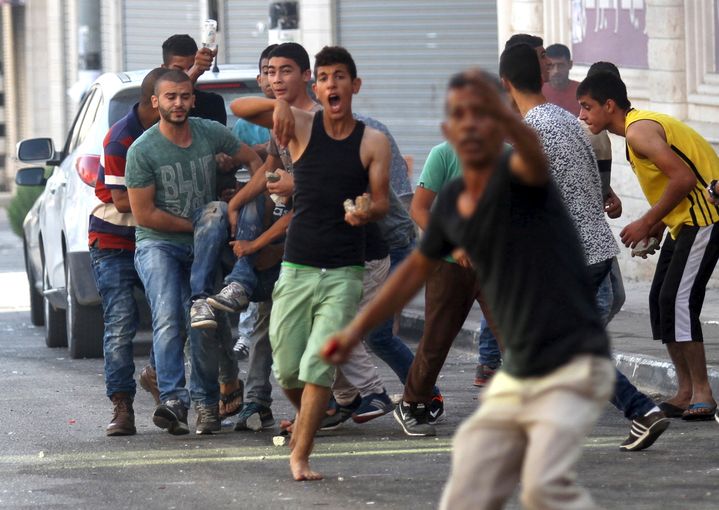 Des Palestiniens transportent l'un des leurs, bless&eacute;s dans un accrochage avec l'arm&eacute;e isra&eacute;lienne, le 4 octobre 2015 &agrave; Jenin (Cisjordanie). (ABED OMAR QUSINI / REUTERS)