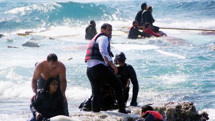 Des habitants et des secouristes viennent en aide à des migrants après leur naufrage au large de l'île de Rhodes (Grèce), le 20 avril 2015. Photo d'illustration. (ARGIRIS MANTIKOS / EUROKINISSI / AFP)