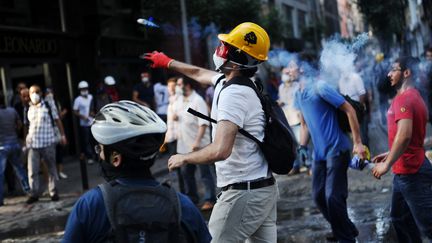 Des manifestants hostiles au gouvernement du Premier ministre turc, Recep Tayyip Erdogan,&nbsp;affrontent la police, dans les rues d'Istanbul (Turquie), le 16 juin 2013. (BULENT KILIC / AFP)