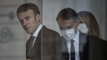 Emmanuel Macron derrière les portes du Palais de l'Elysée à Paris (France) le 14 février 2022&nbsp; (LUDOVIC MARIN / AFP)