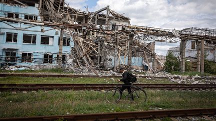 Un homme passe devant&nbsp;une usine détruite par des bombardements russes à Soledar, dans le Donbass (Ukraine), le 22 mai 2022. (SOPA IMAGES / LIGHTROCKET / GETTY IMAGES)