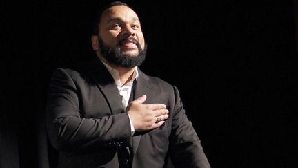 Dieudonn&eacute; ex&eacute;cute une "quenelle",&nbsp;le 15 janvier 2012 au th&eacute;&acirc;tre de la Main d'or, &agrave; Paris. (PATRICK KOVARIK / AFP)