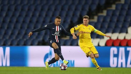 Kylian Mbappe en action lors du dernier match officiel du PSG le 11 mars 2020 face à Dortmund en 8e de finale de Ligue des Champions. (- / GETTY/UEFA)